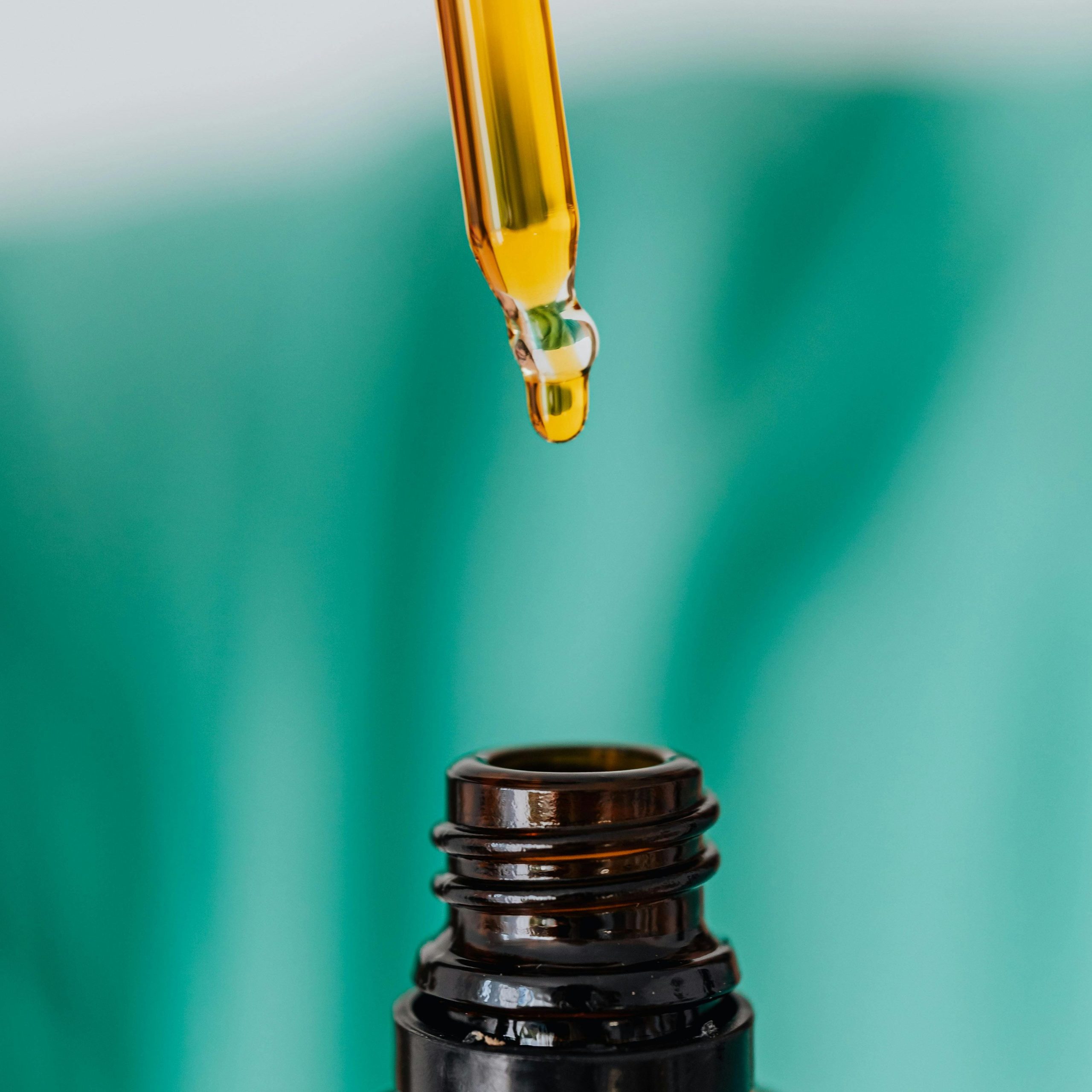 Brown glass bottle with liquid and pipette